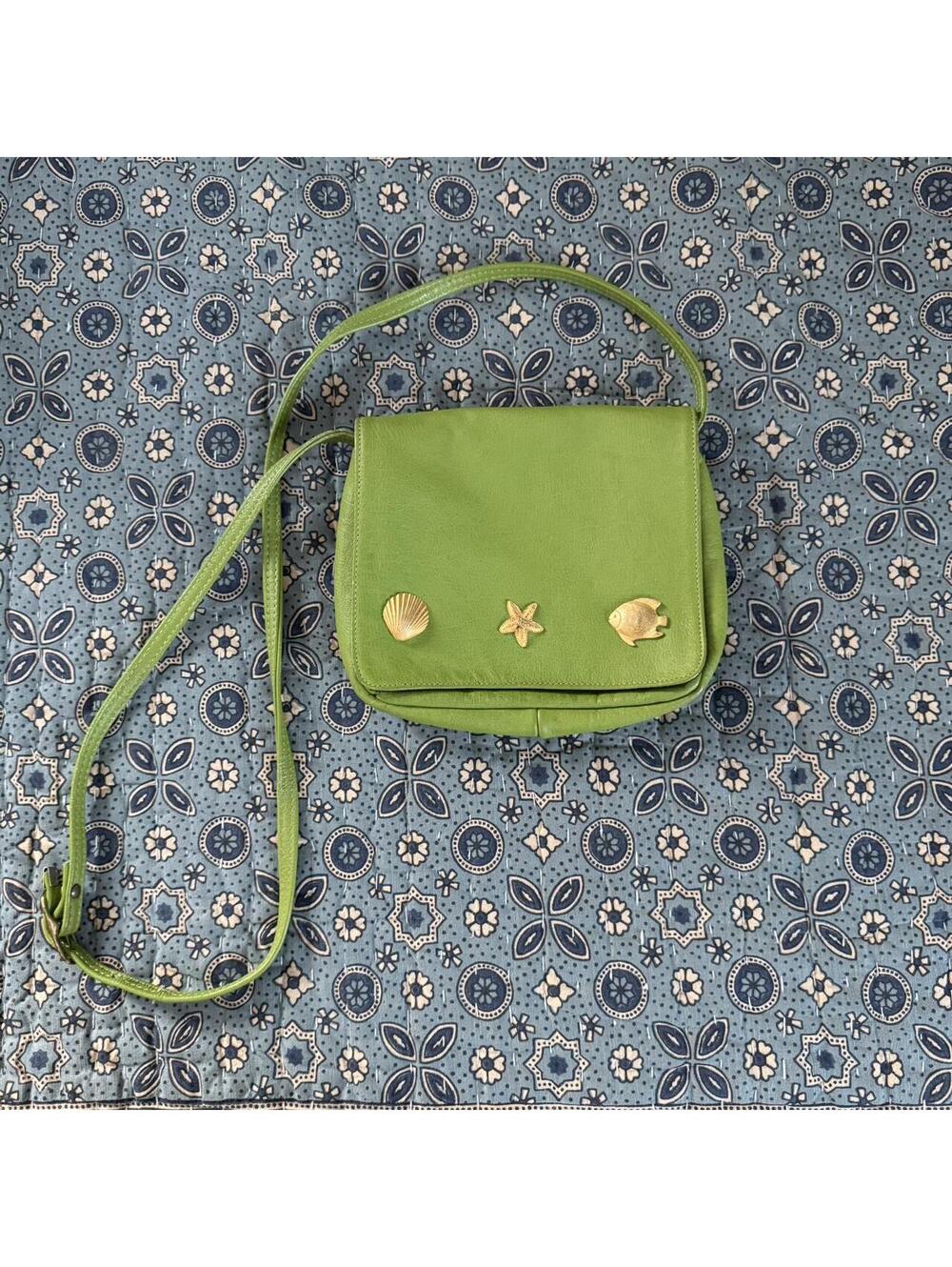 Green small faux leather shoulder bag with gold fish and seashell charms